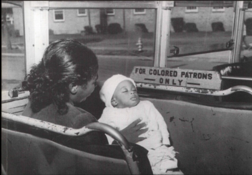 Mother and Child on bus with sign on seat