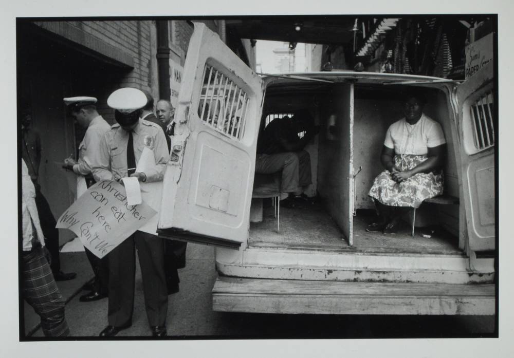 AN ANTI-SEGREGATION PROTESTER SITS IN A POLICE VEHICLE FOLLOWING HER ARREST   COURTESY OF BRUCE DAVIDSON / JCM COLLECTION 